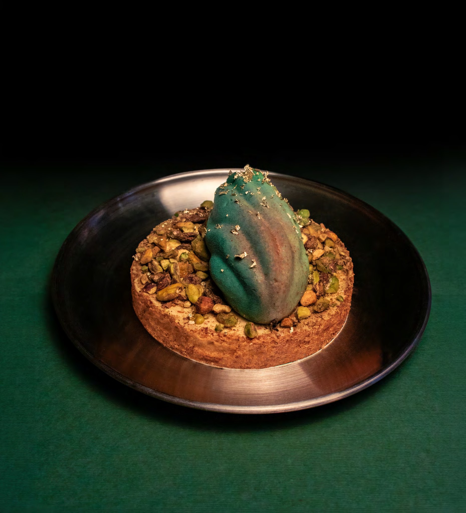 A sculptural Delysées dessert presented on a dark plate